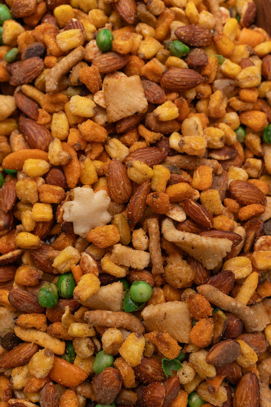 Close up of assorted nuts, corn and rice crackers