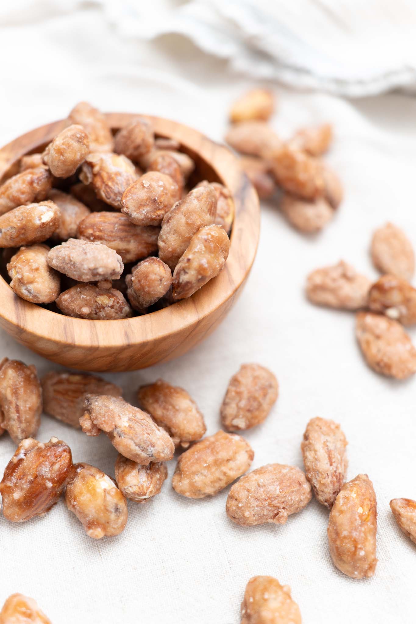 Wooden bowl filled with honey roasted almonds