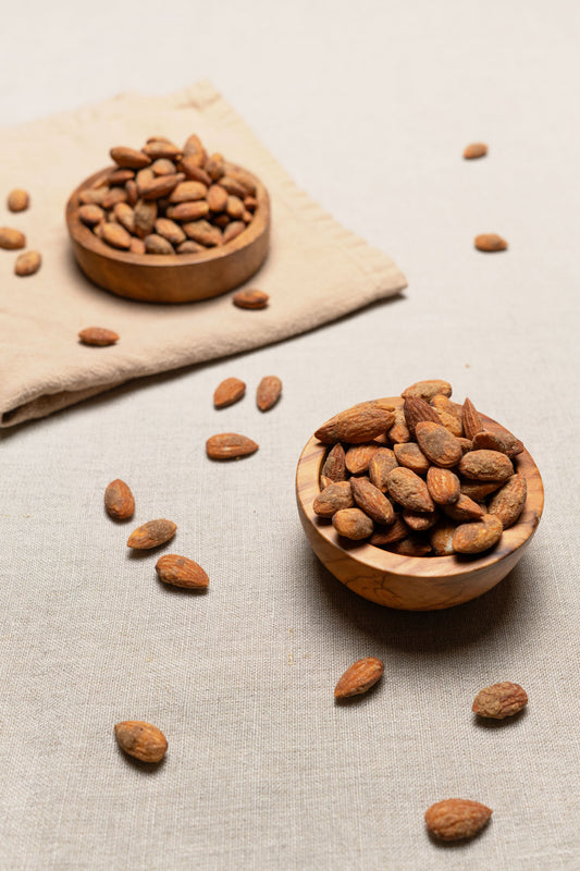 Wooden bowl filled with romano ranch seasoned almonds