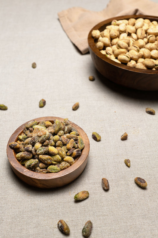Wooden bowl filled with unshelled honey roasted pistachios