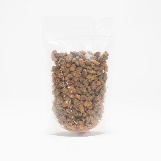 Back view of a clear bag of unshelled smokey BBQ pistachios