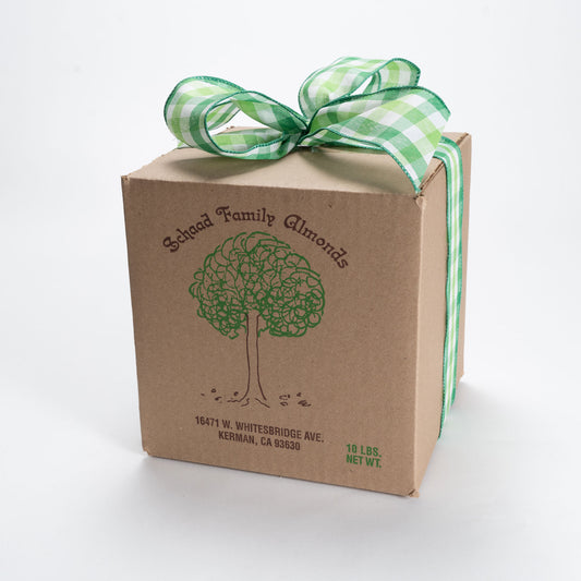 Cardboard box topped with a green bow, and labeled with the Schaad Family Almonds logo