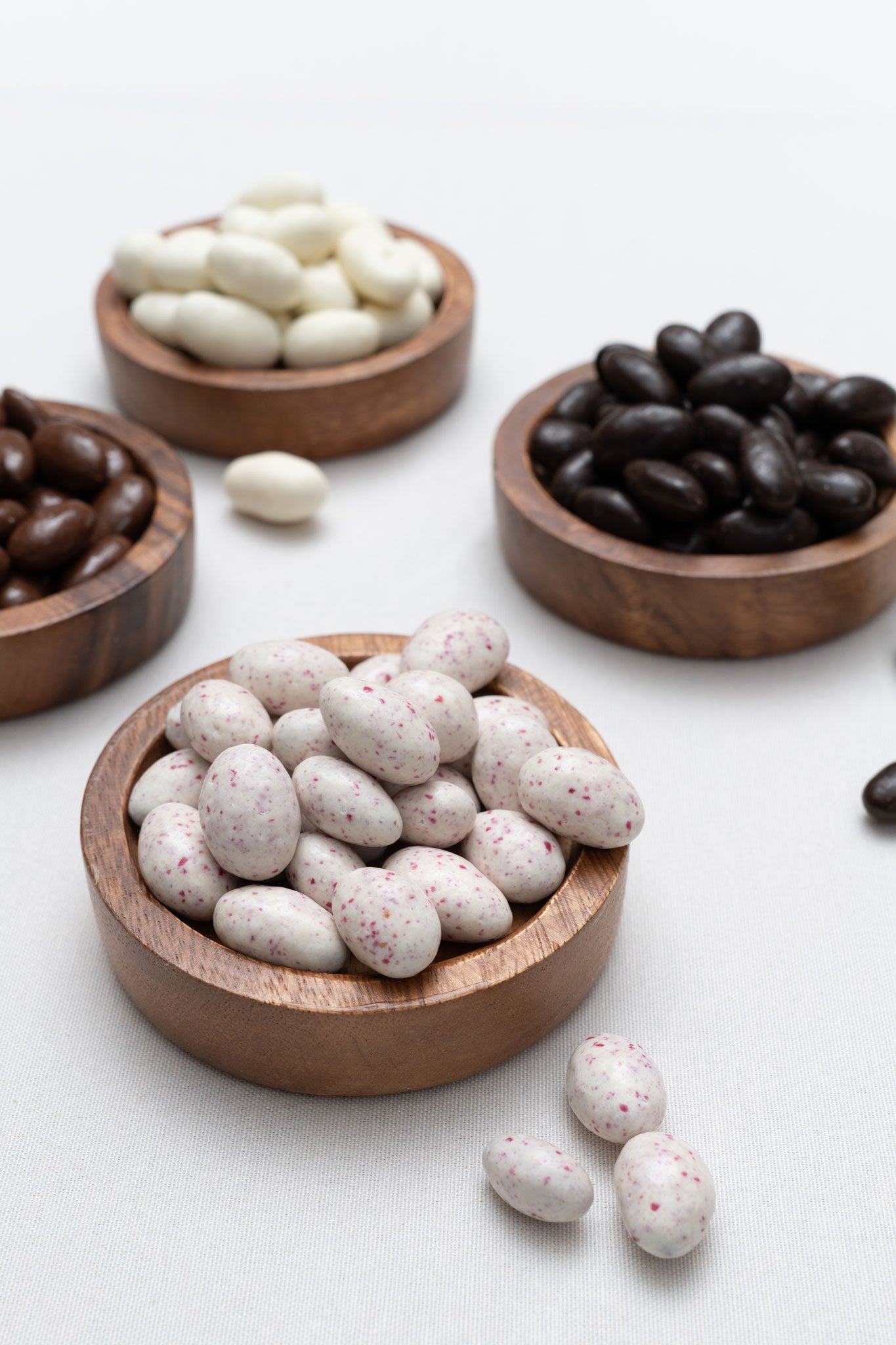Candied almonds in small wooden bowls