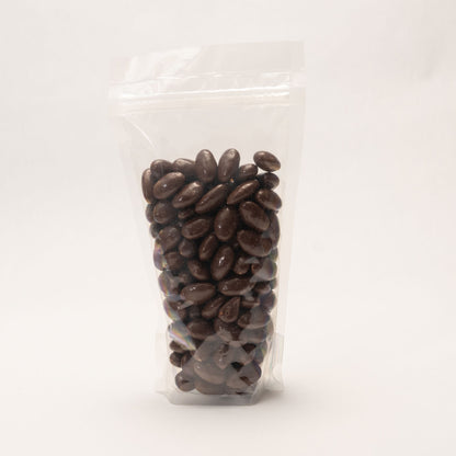 Back view of a clear bag filled with chocolate and sea salt covered almonds
