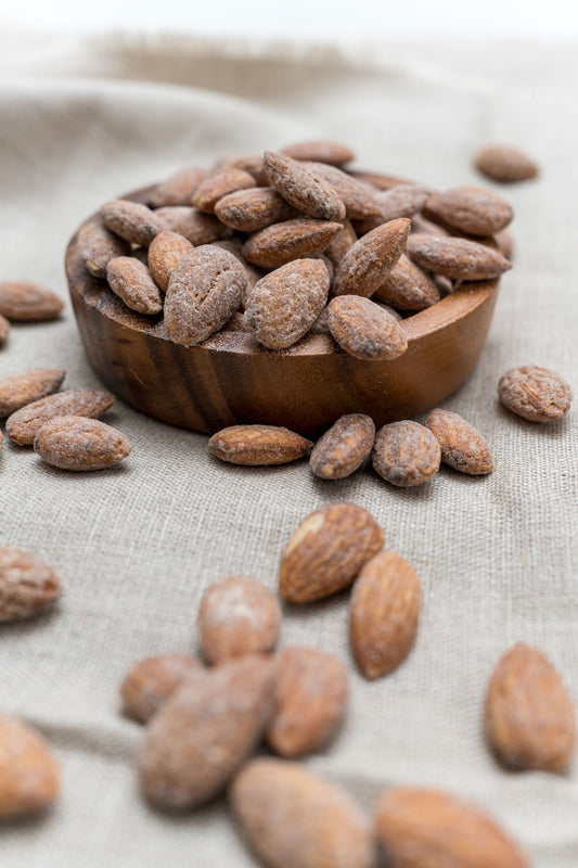 Wooden bowl filled with cinnamon glazed almonds
