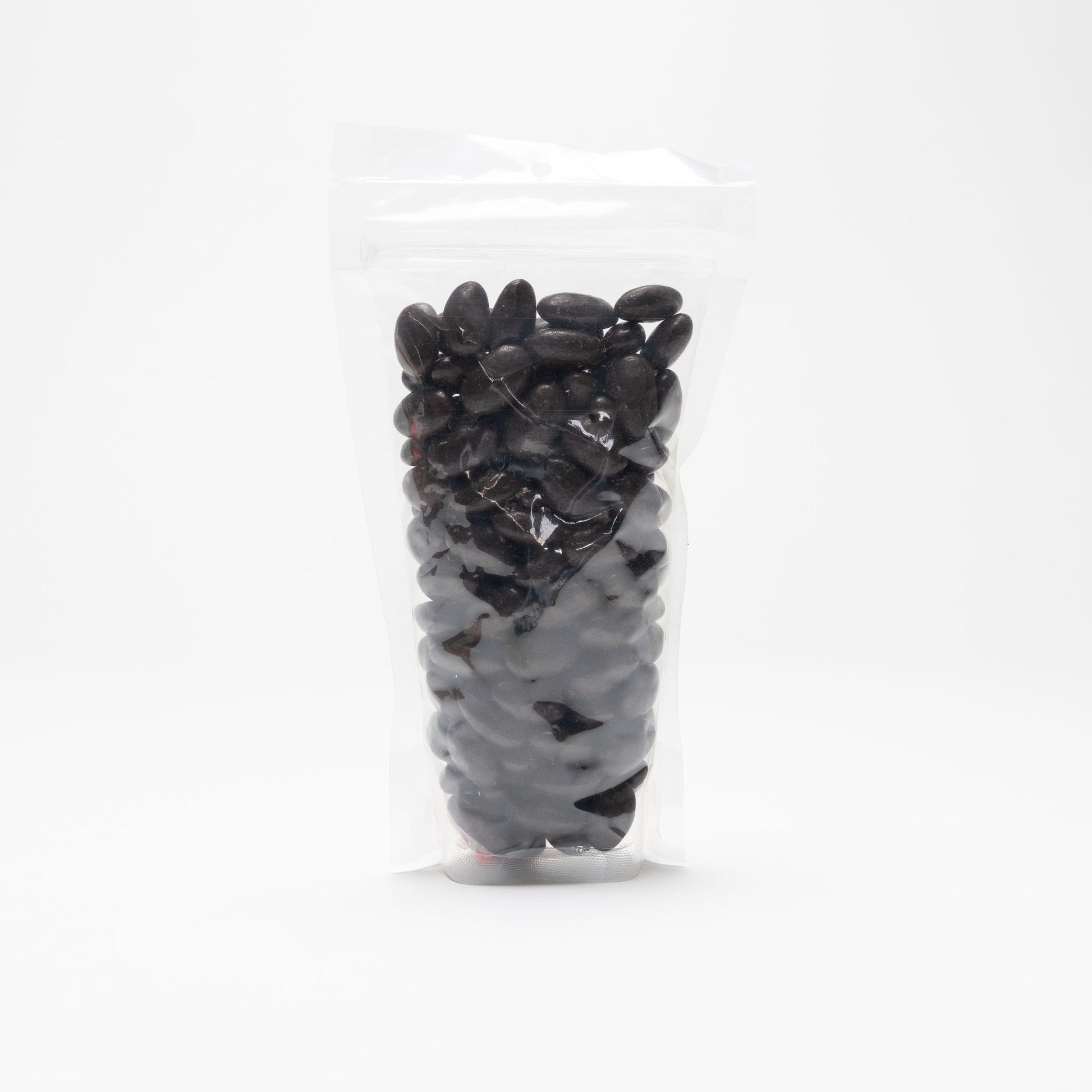 Back view of a clear bag of dark chocolate covered almonds