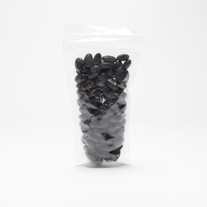 Back view of a clear bag of dark chocolate covered almonds
