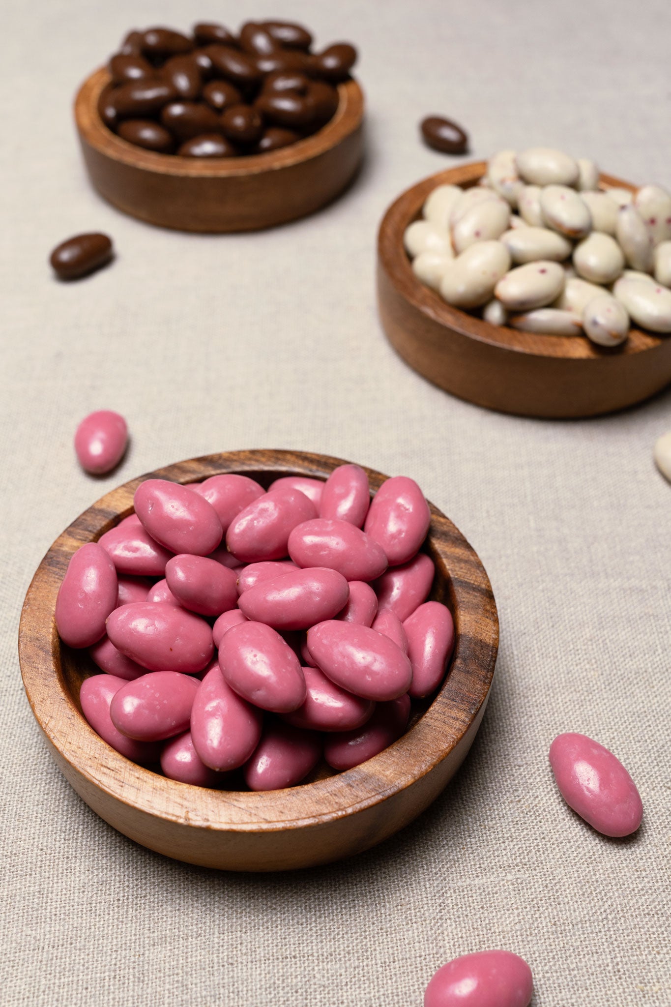 Wooden bowl filled with pomegranate yogurt candied almonds