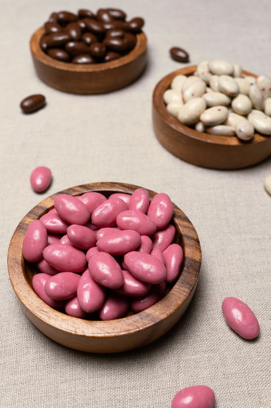 Wooden bowl filled with pomegranate yogurt candied almonds