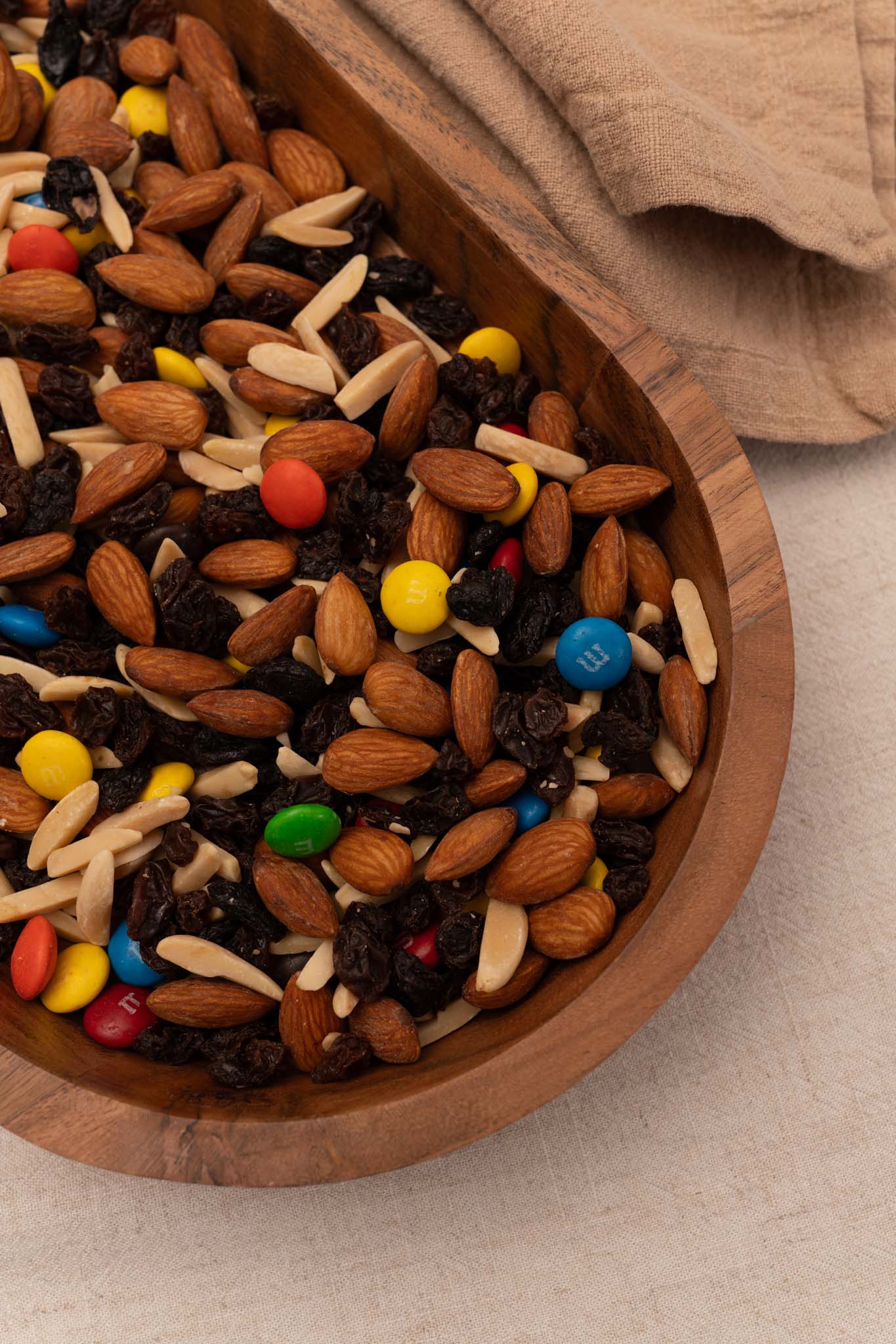 Wooden bowl filled with almond trail mix