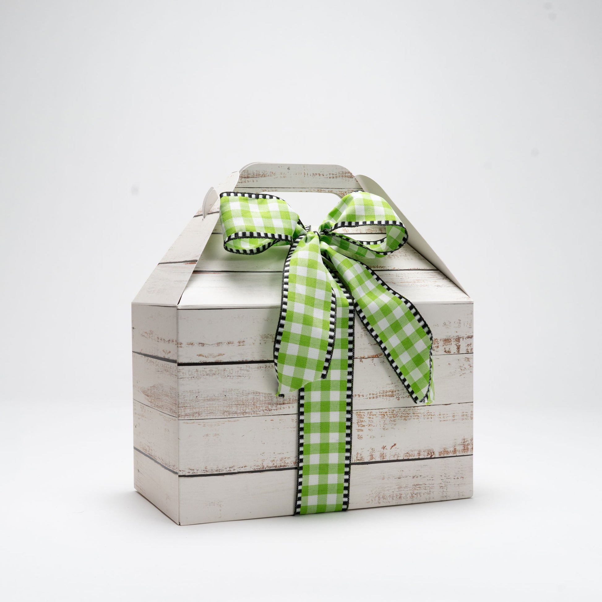 Cardboard box wrapped with a bow on a white background
