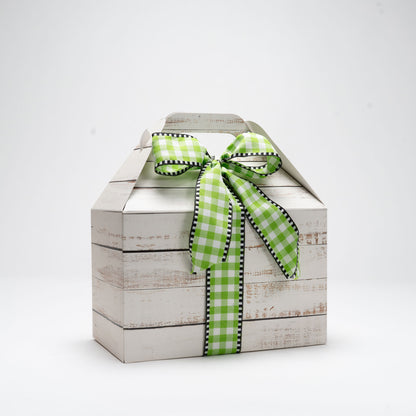 Cardboard box wrapped with a bow on a white background