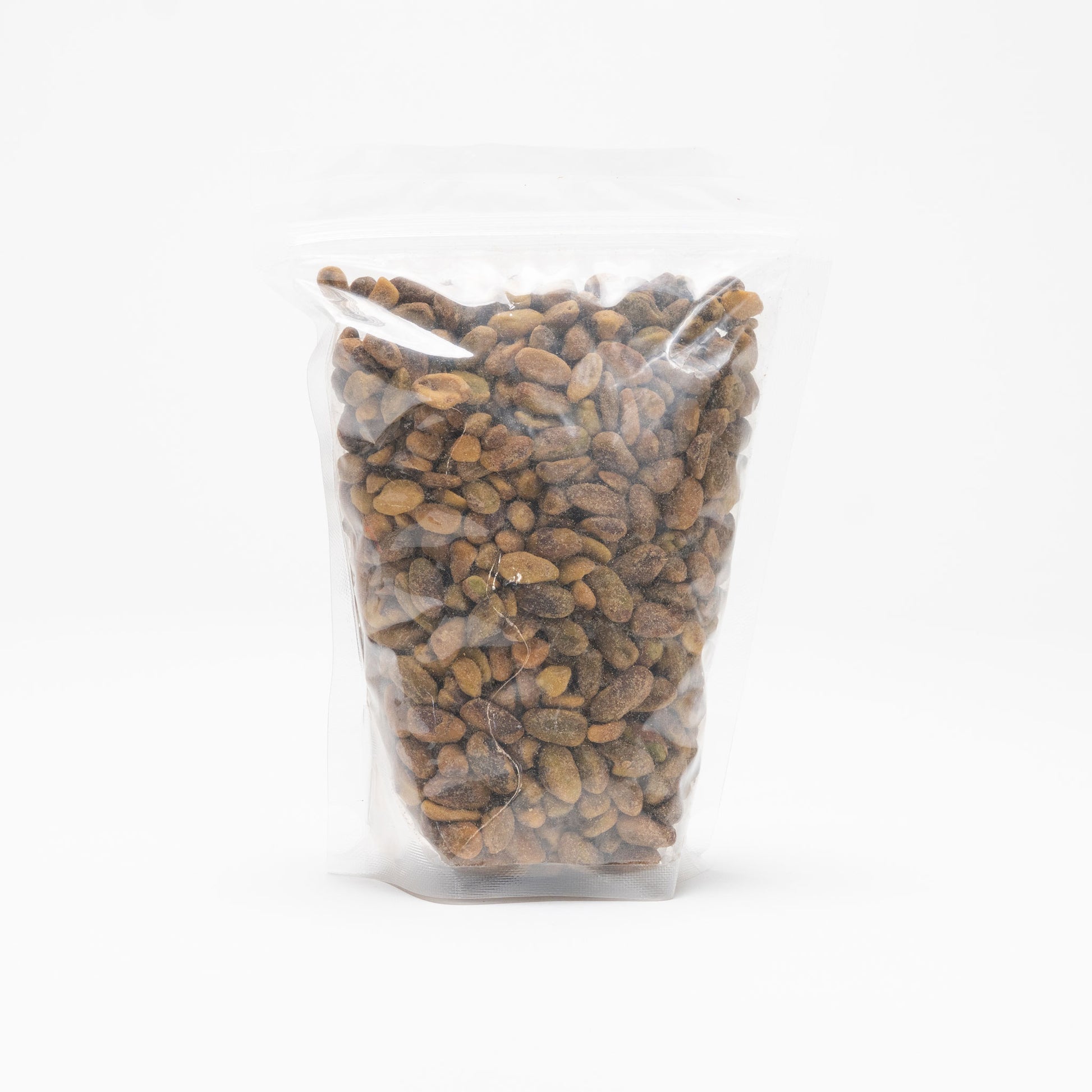 Back view of a clear bag of unshelled roasted and slated pistachios