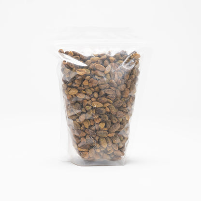 Back view of a clear bag of unshelled roasted and slated pistachios