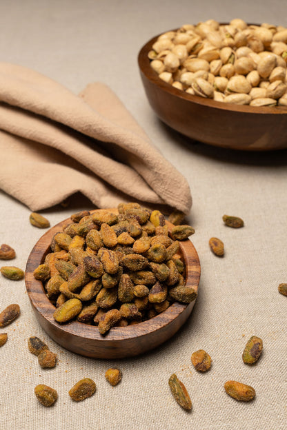 Wooden bowl filled with Smoky BBQ pistachio meats