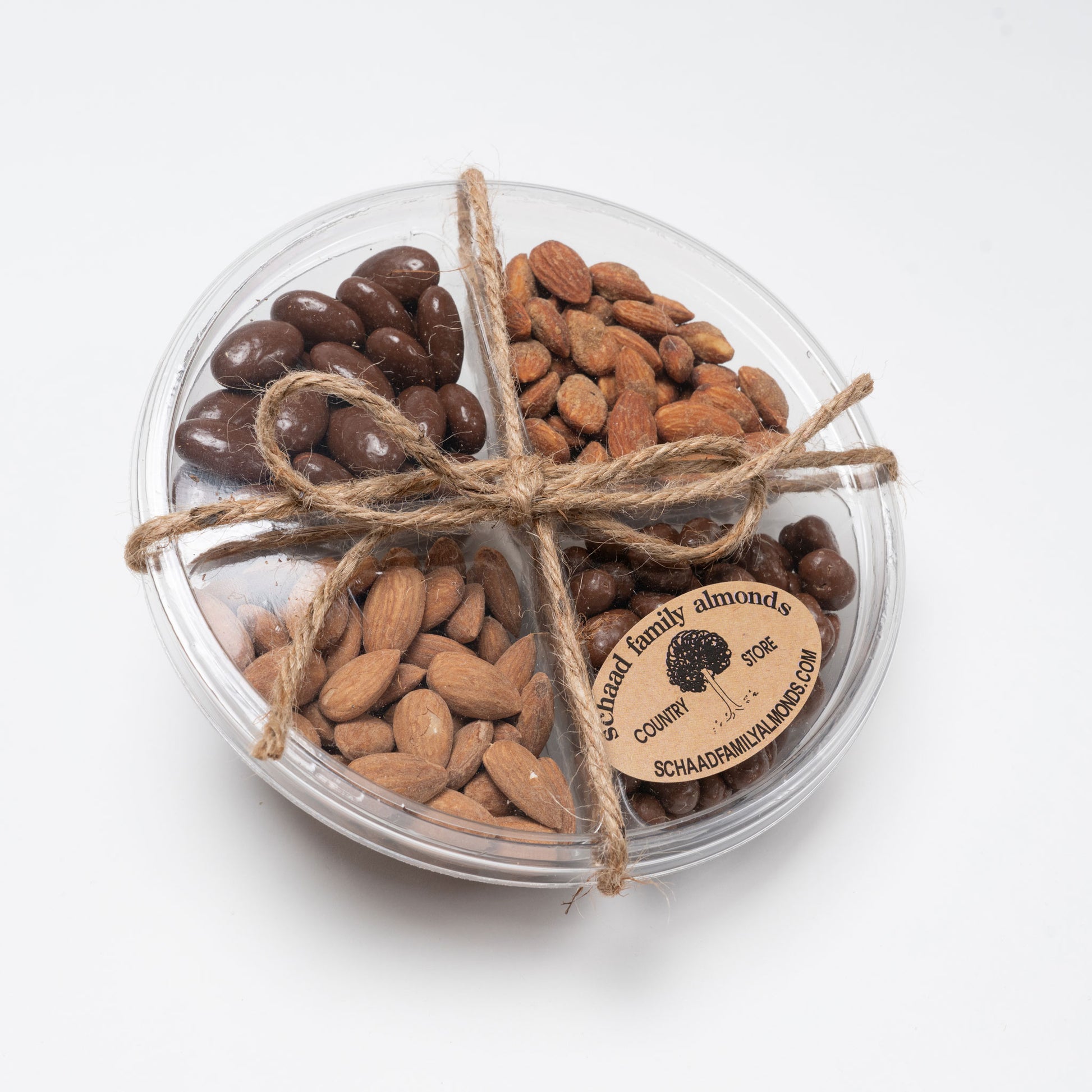 Plastic tray with assorted salted and candied nuts on a white background