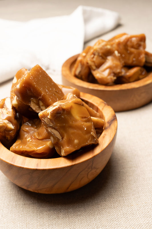 Wooden bowl filled with almond caramel chews
