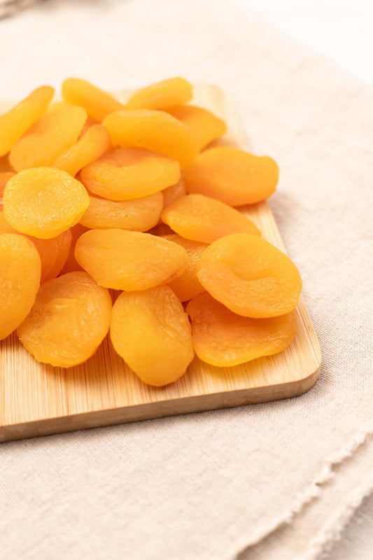 Dried apricots on a bamboo board