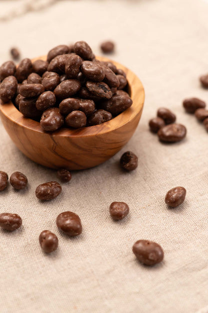 Wooden bowl filled with chocolate covered raisins