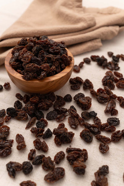 Wooden bowl filled with natural raisins