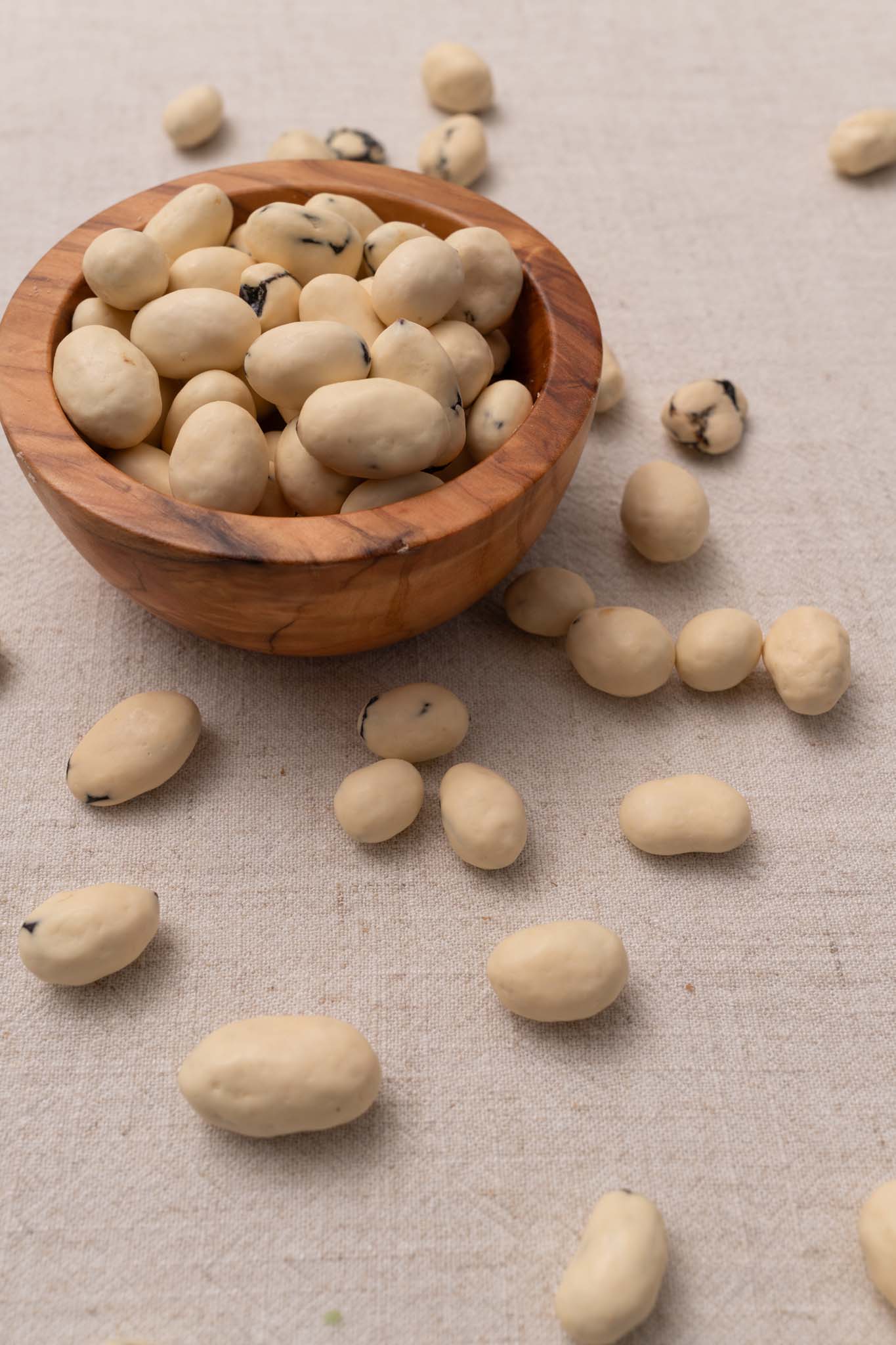 Wooden bowl filled with yogurt covered raisins