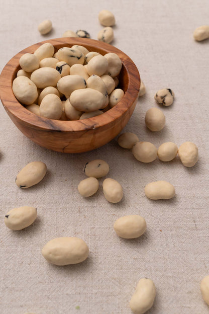 Wooden bowl filled with yogurt covered raisins